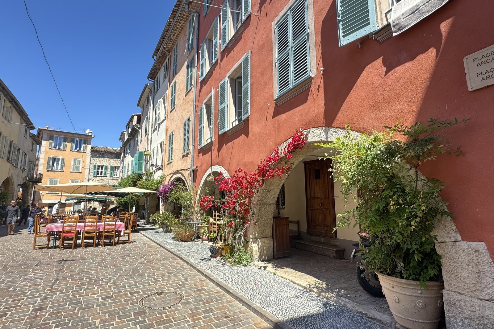 Place des Arcades in Biot, restaurant tables under the arches